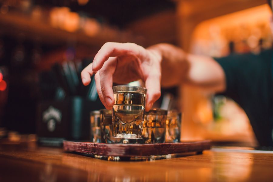 Bartender serves tequila