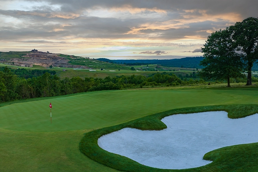 a calm green at buffalo ridge with sunset sky