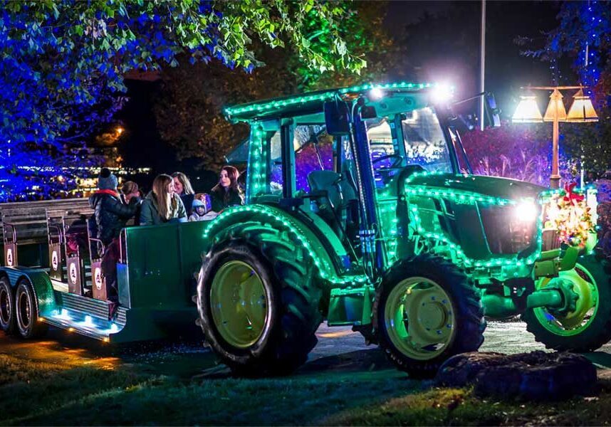 Tractor coveredin Christmas Lights driving through Big Cedar light display