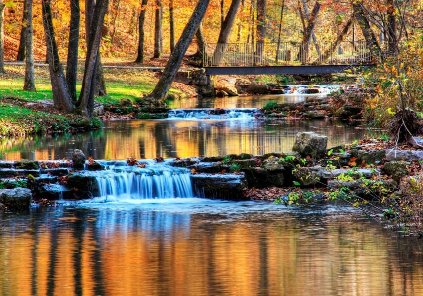 Dogwood Canyon Nature Park walking path and bridge over streams and waterfalls at Big Cedar.