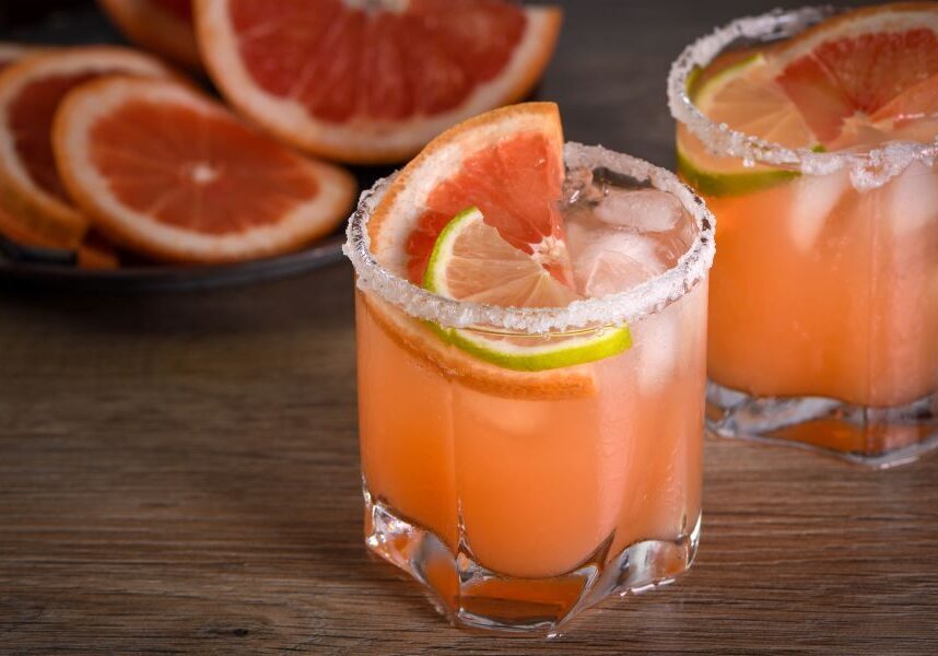 pink paloma cocktail garnished with line and grapefruit