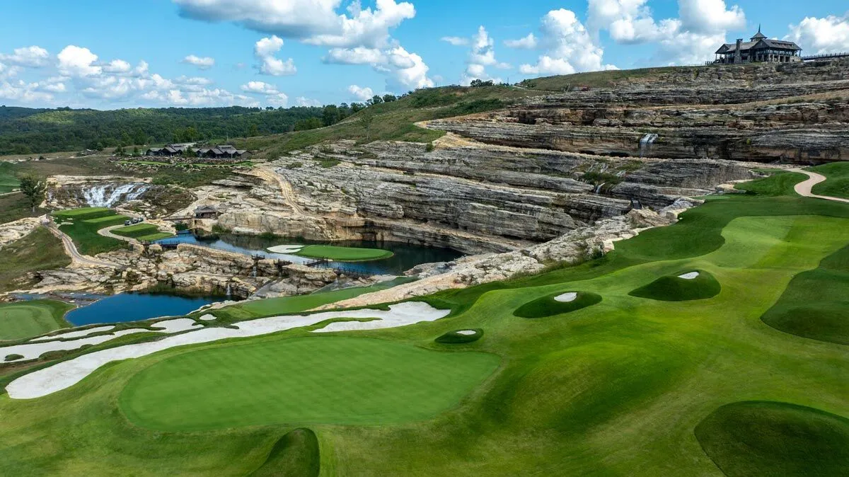 Uniquely shaped bunkers line a rolling hole that overlooks a pond at Cliffhangers golf course at Big Cedar Lodge