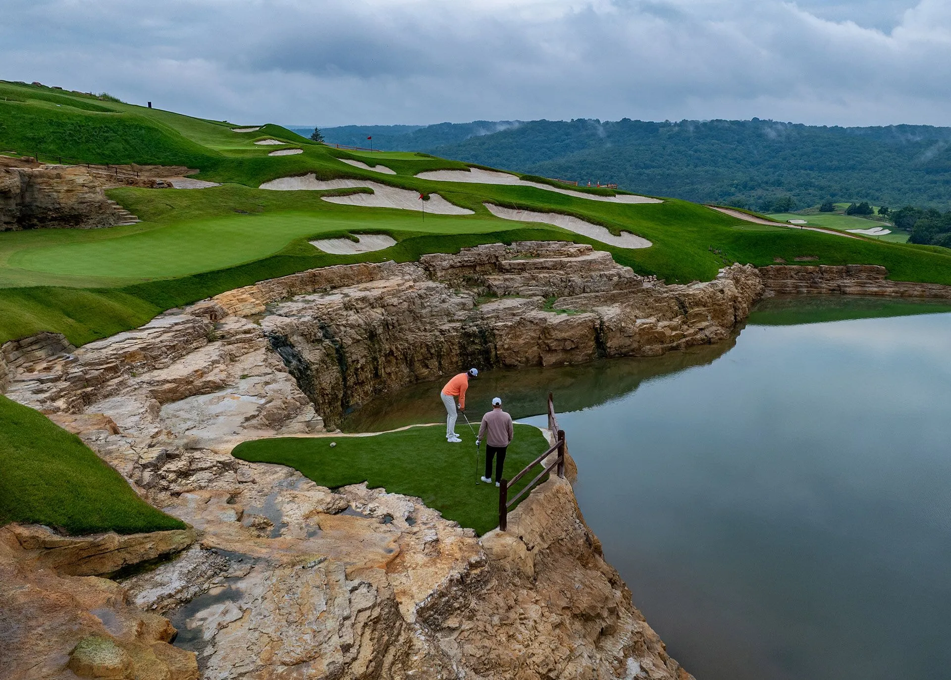golfers tee off at cliff side tee at cliffhangers golf course