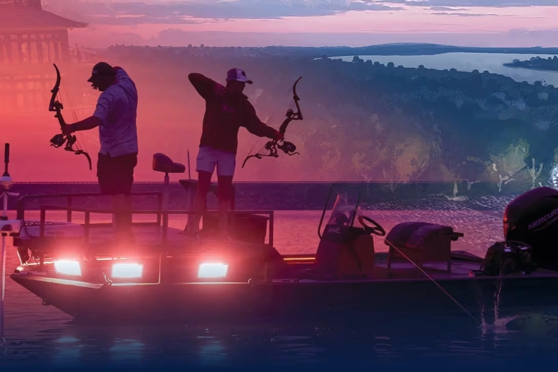 Two bowfishermen take aim while standing on a boat overlooking Table Rock Lake