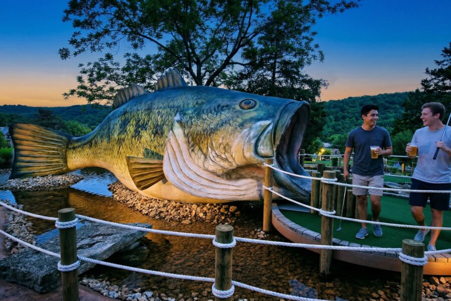 two men Enjoy beer and mini golf at night