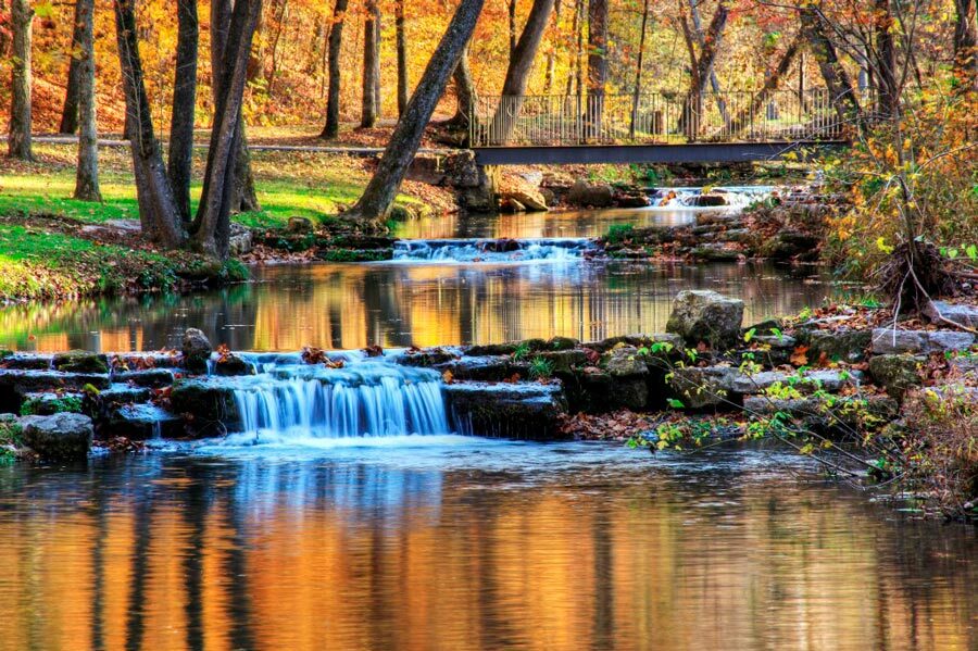 Dogwood Canyon Nature Park walking path and bridge over streams and waterfalls at Big Cedar.