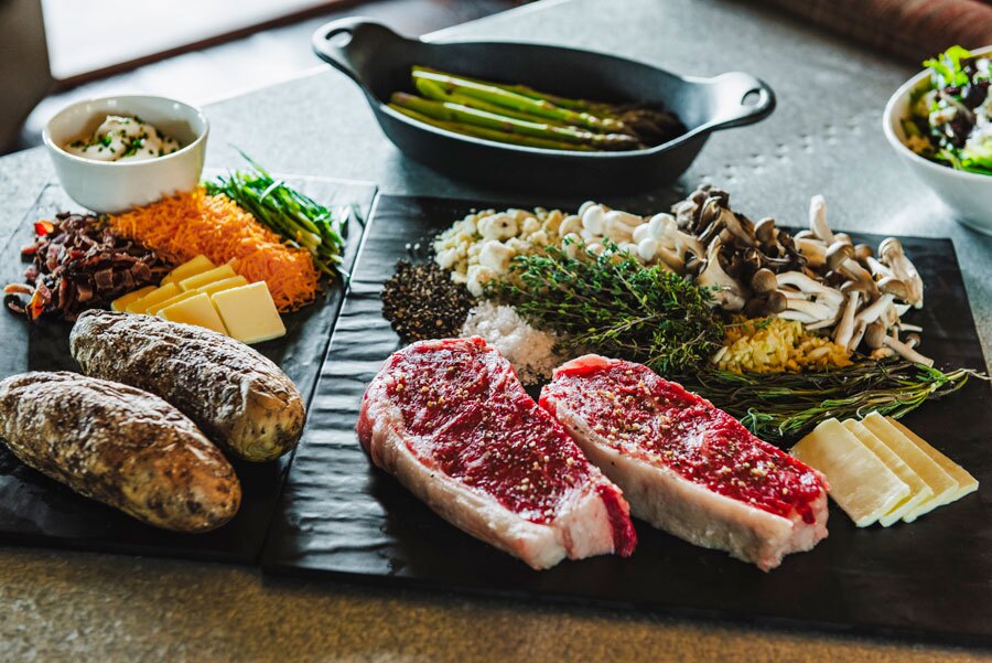 Steak, asparagus, stuffed baked potato and salad as part of the Backyard Basket at Big Cedar dining and room service