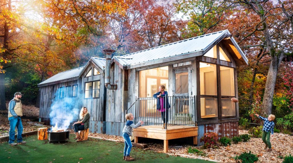 Family playing outside of their Camp Cabin at Camp Long Creek while glamping at Big Cedar Lodge