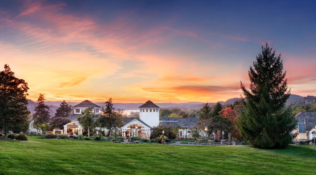 Early morning external view of the lawn and sunrise of the registration and spa buildings at Big Cedar Lodge main check-in.