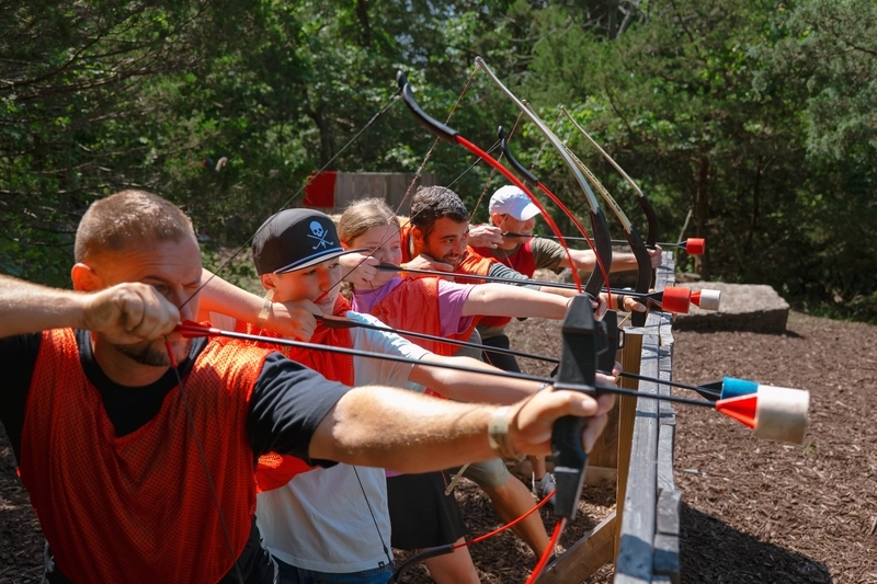 Line of men with with bows and padded arrows