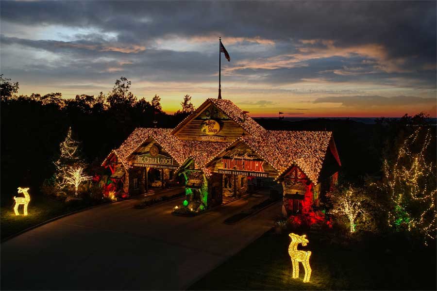 The gates of Big Cedar Lodge and Top of the Rock twinkle with Christmas lights in the twilight.