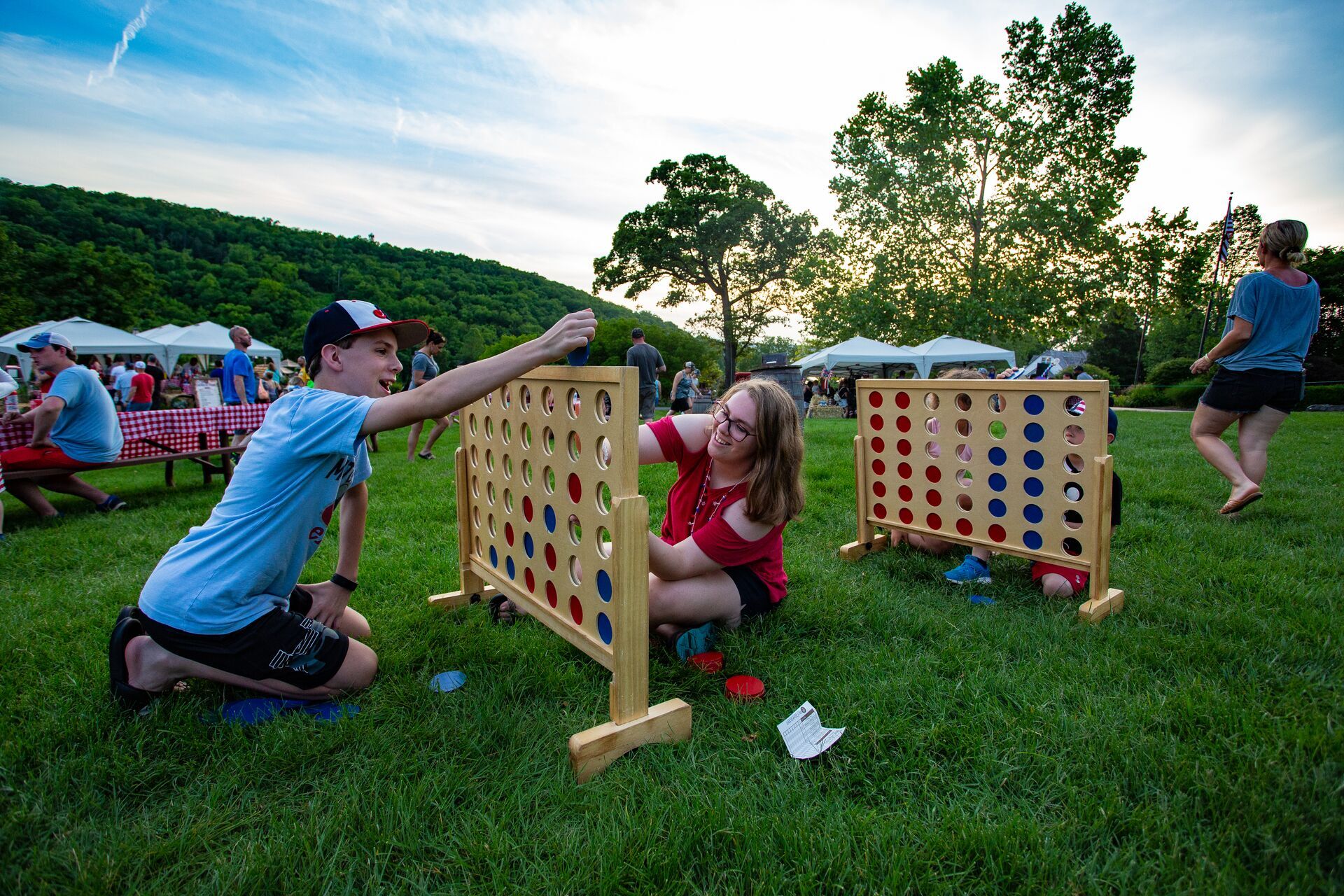 kids play big connect four game at memorial day picnic