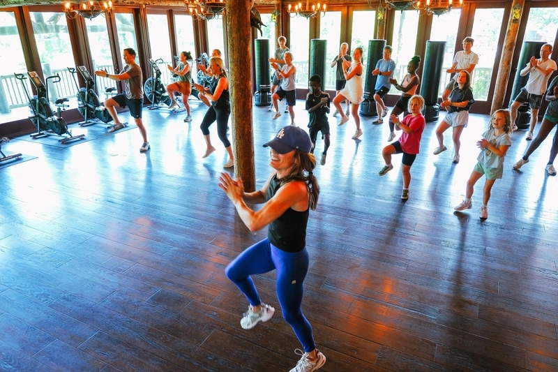 Trainer leading a group of people dancing