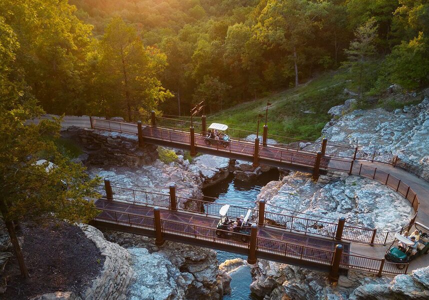 A horseshoe turn on the Lost Canyon Cave & Nature Trail with three golf carts traversing the trail.