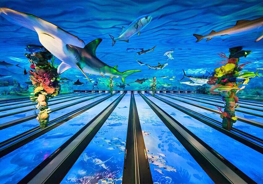 Sharks, stingrays, and fish figures are suspended above the Fun Mountain Bowling Lanes.