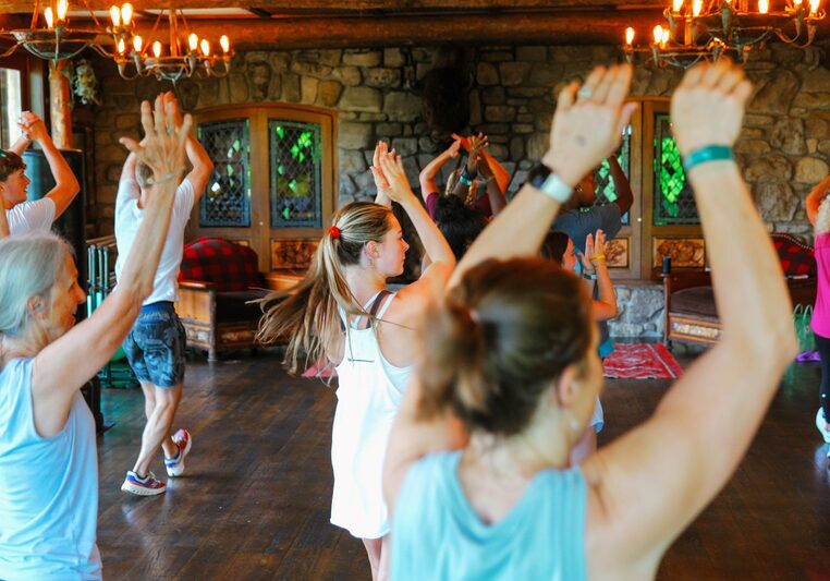 People in work out clothes with hands raised