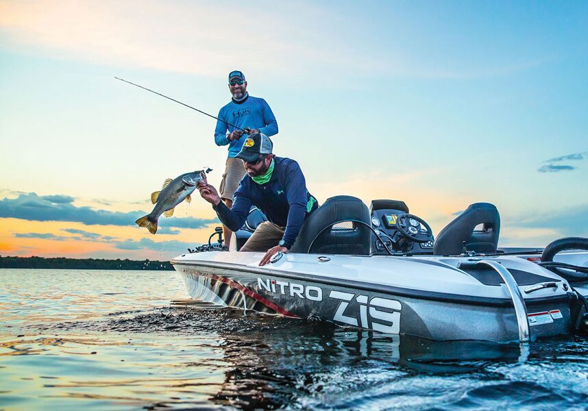 Two fishermen out on a Nitro Z19 fishing boat at Big Cedar pulling in a bass on Table Rock Lake