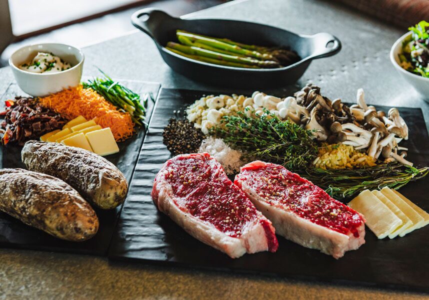 Steak, asparagus, stuffed baked potato and salad as part of the Backyard Basket at Big Cedar dining and room service