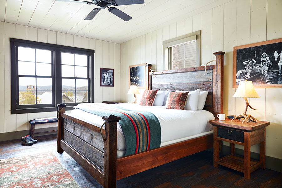 Bass Pro Shops Lakeside Two Bedroom Cottage room at Big Cedar Lodge. Pictured is a bed and rustic decor.