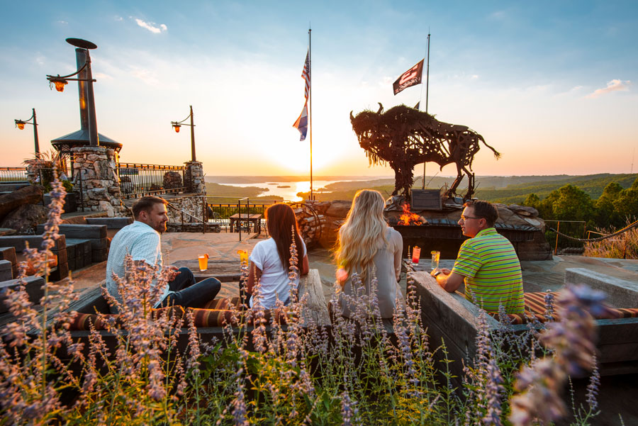 Couples on the patio at Buffalo Bar enjoying outdoor casual dining with view of the valleys and Table Rock Lake at Top of the Rock at Big Cedar