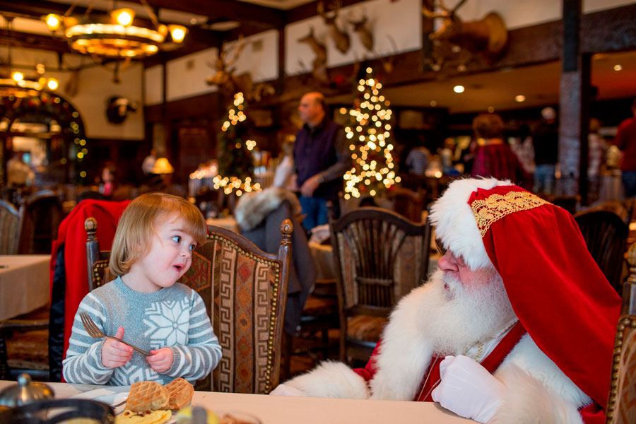 Santa Clause meets excited little girl at holiday breakfast at Big Cedar