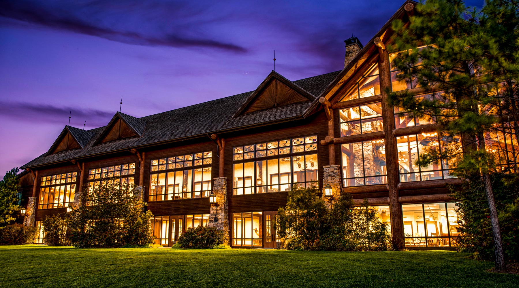 Grandview Conference Center night view exterior as it sheds light on large outdoor lawn space at Big Cedar.