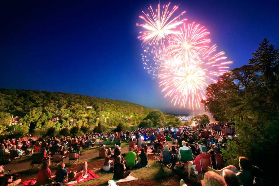 Fireworks light up the sky while people watch from the Lawn on July Fourth at Big Cedar