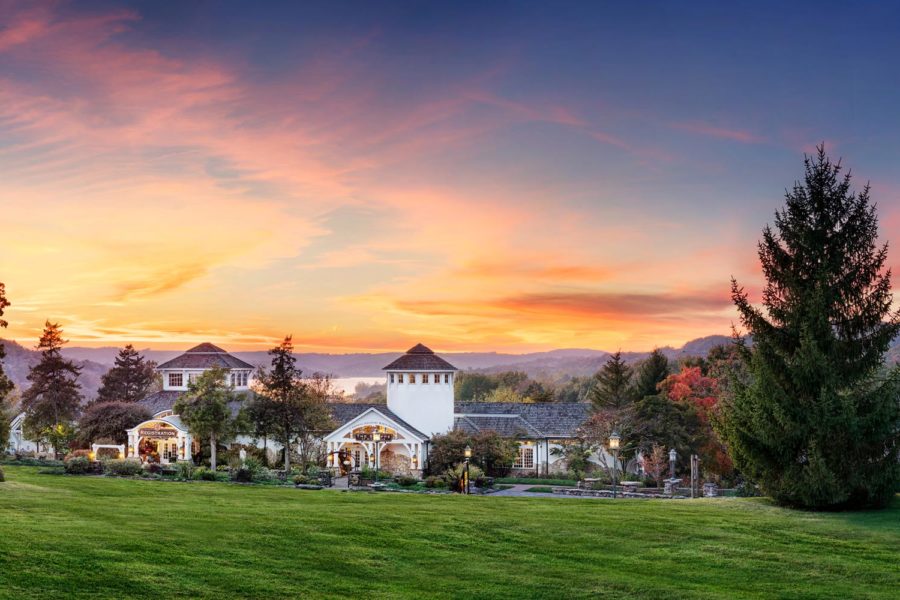 Early morning external view of the lawn and sunrise of the registration and spa buildings at Big Cedar Lodge main check-in.