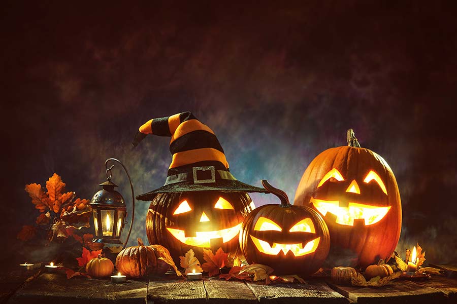 Spooky Jack-o-lanterns in front of black background