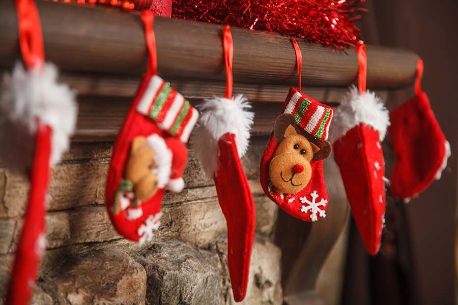 Six stockings hanging on a mantel