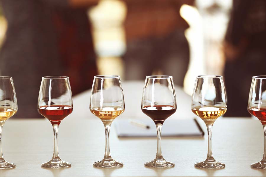 Six glasses lined up for wine tasting