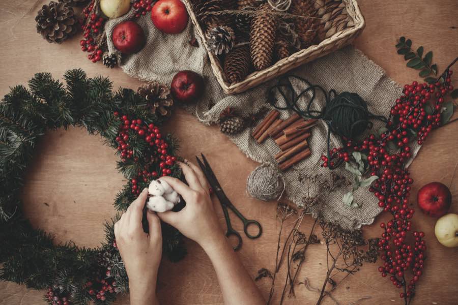 Hands crafting a cristmas wreath