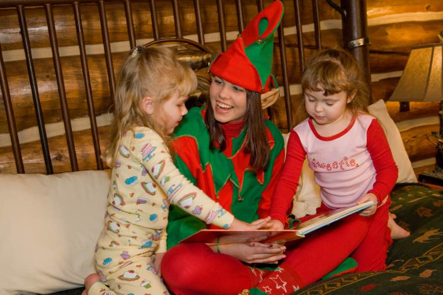 Elf reading to two children
