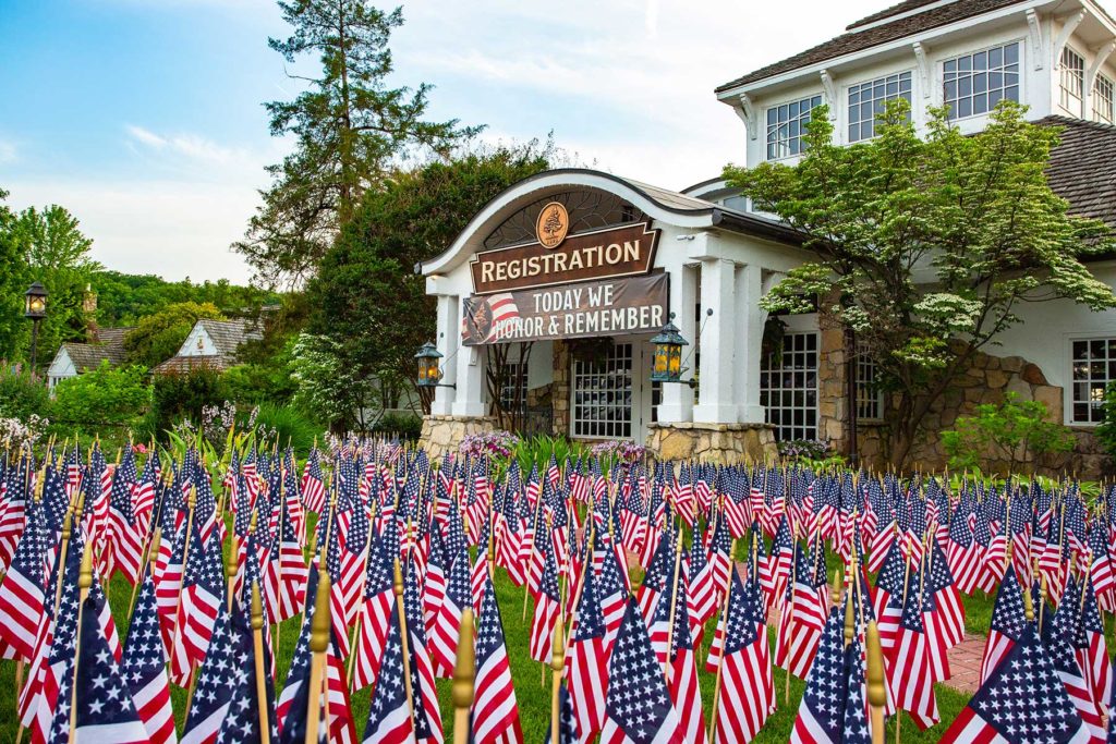 Big Cedar Lodge registration building with American flags filling the yard