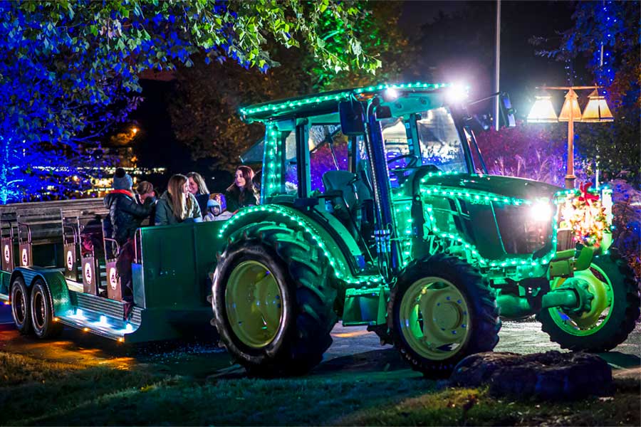 Tractor coveredin Christmas Lights driving through Big Cedar light display