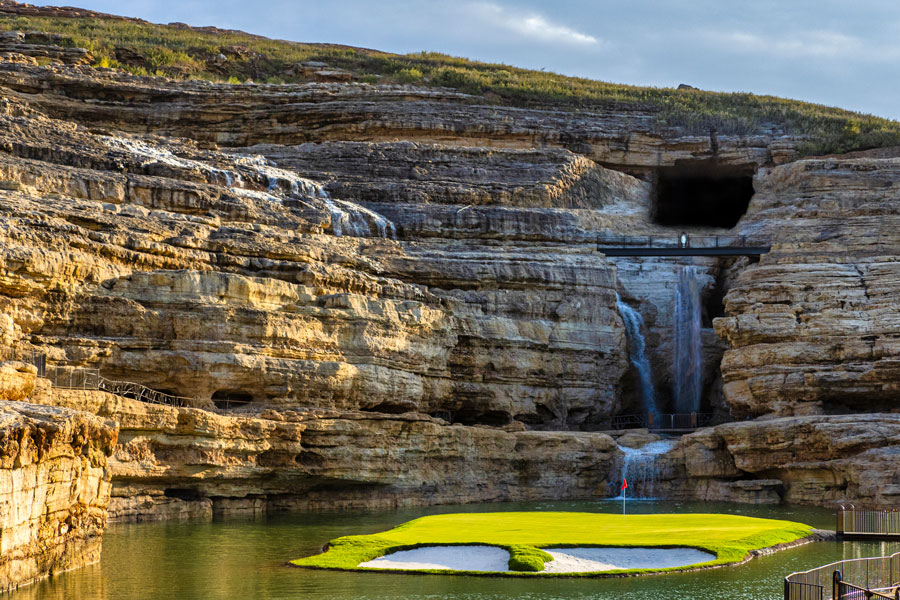 The 19th hole at Payne's Valley with cave and waterfall in the background