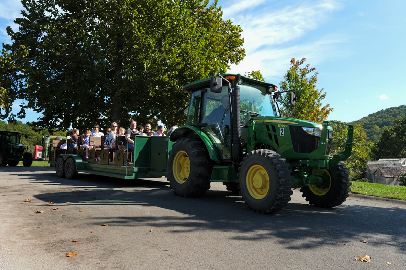 John Deer Tractor pulling an open air tram