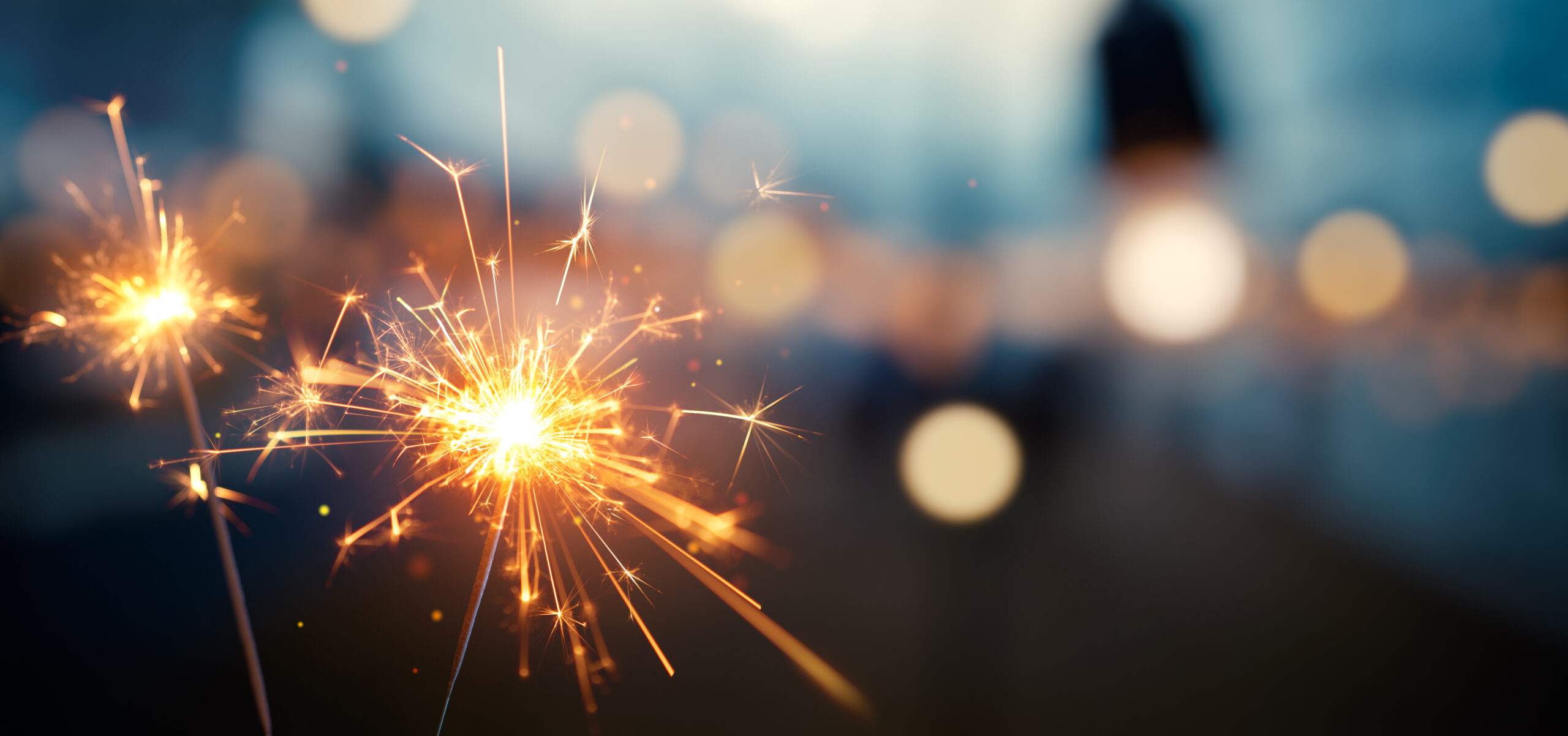 Burning sparkler with bokeh light background