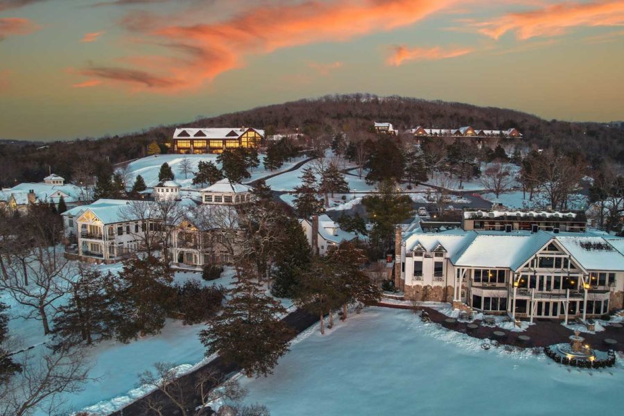 Big Cedar covered in snow with glowing sunset above.