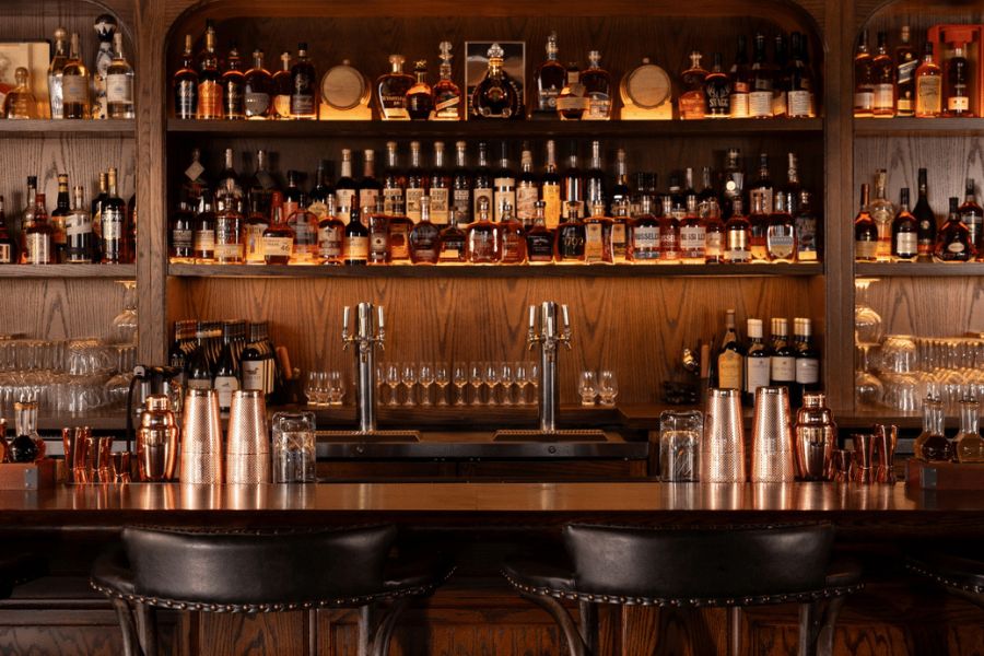 The Harry's Cocktail Lounge Bar sits clean and stocked with high quality bourbon whiskey.