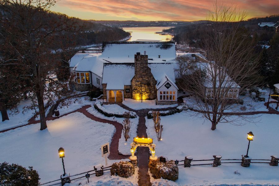 The sun sets over the snow-covered Worman House