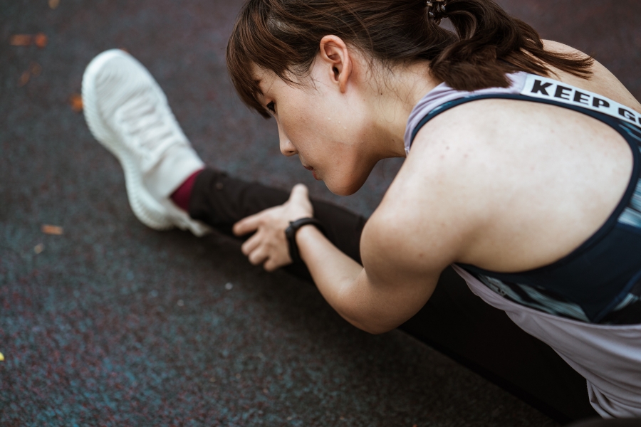 A woman stretches during a workout.