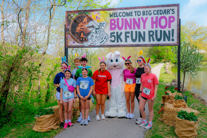 Runners gather around the Easter bunny at the 5k finish line