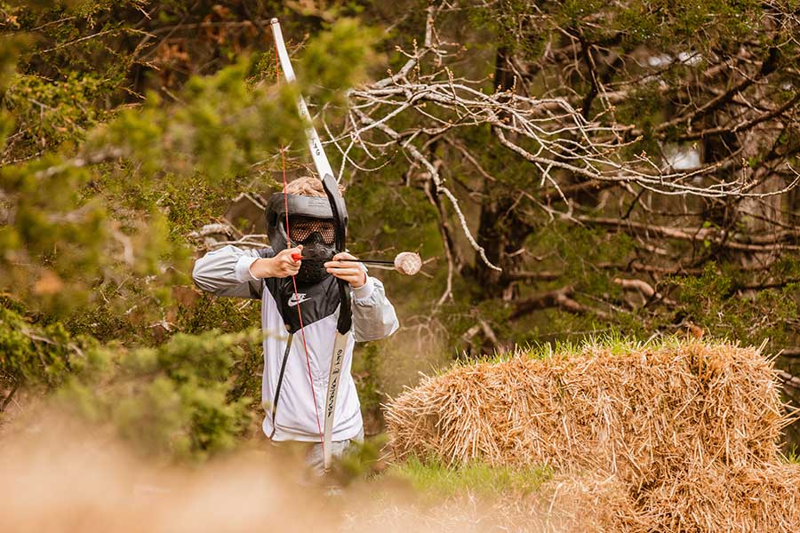 A young man playing archery tag at Big Cedar Lodge