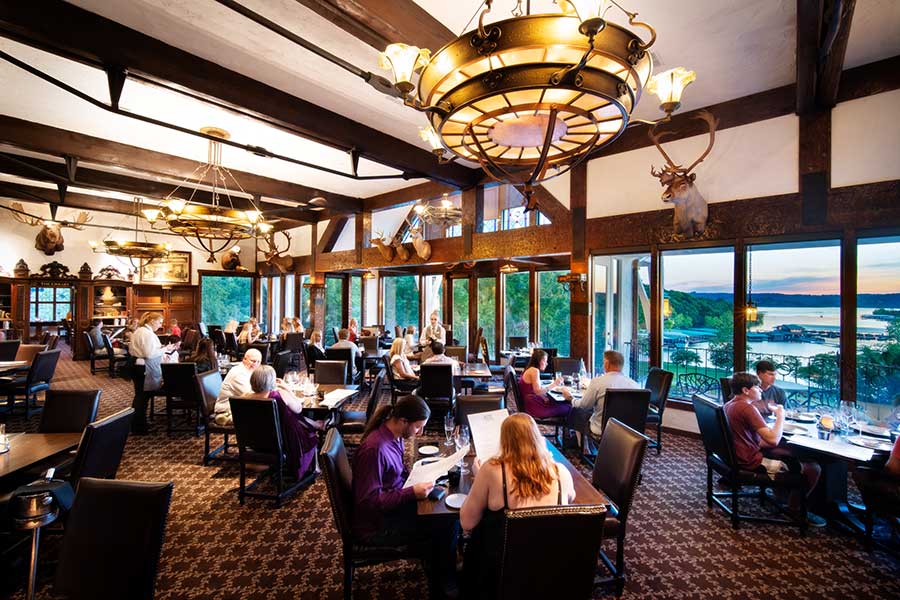 Guests enjoy dinner with a lakeside sunset view at the Historic Worman House Bistro, overlooking Table Rock Lake