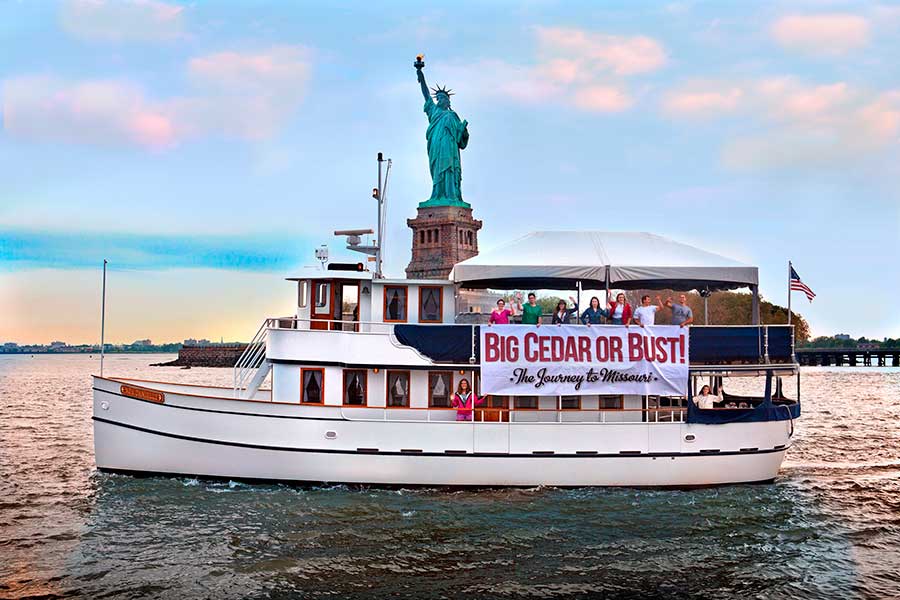 Big Cedar's newly acquired Lady Liberty departing New York, with the Statue of Liberty behind her.