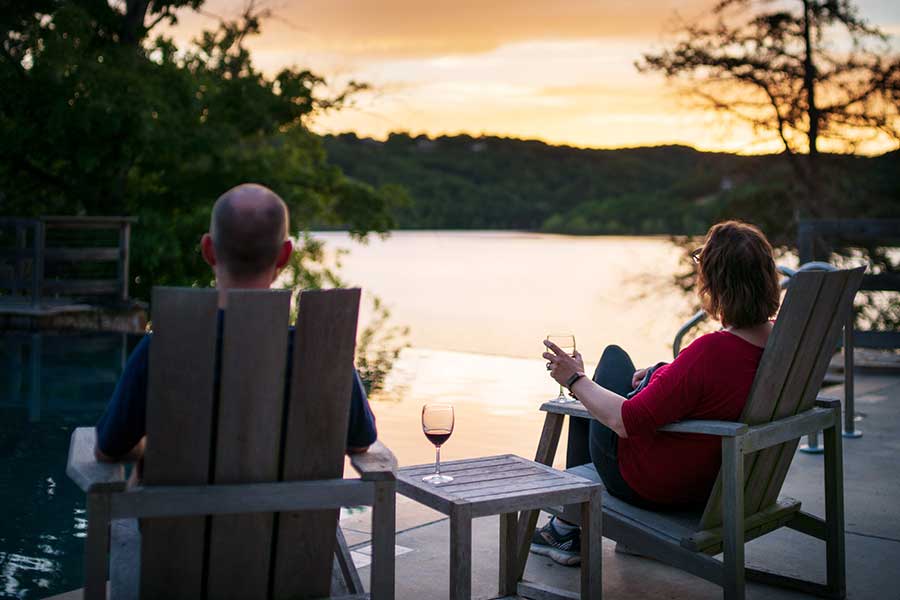 A couple enjoys a glass of wine near the pool, overlooking Table Rock Lake