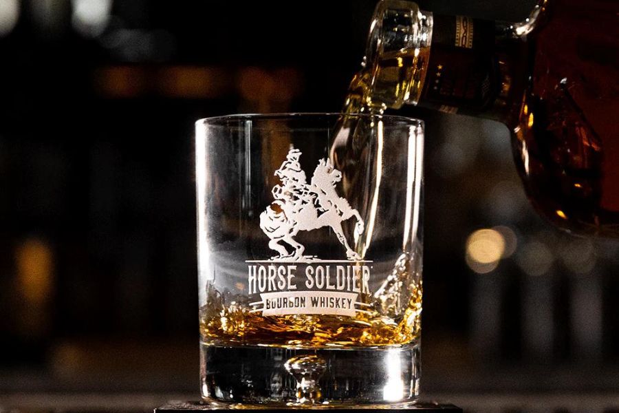 A glass etched with Horse Soldier Bourbon Logo