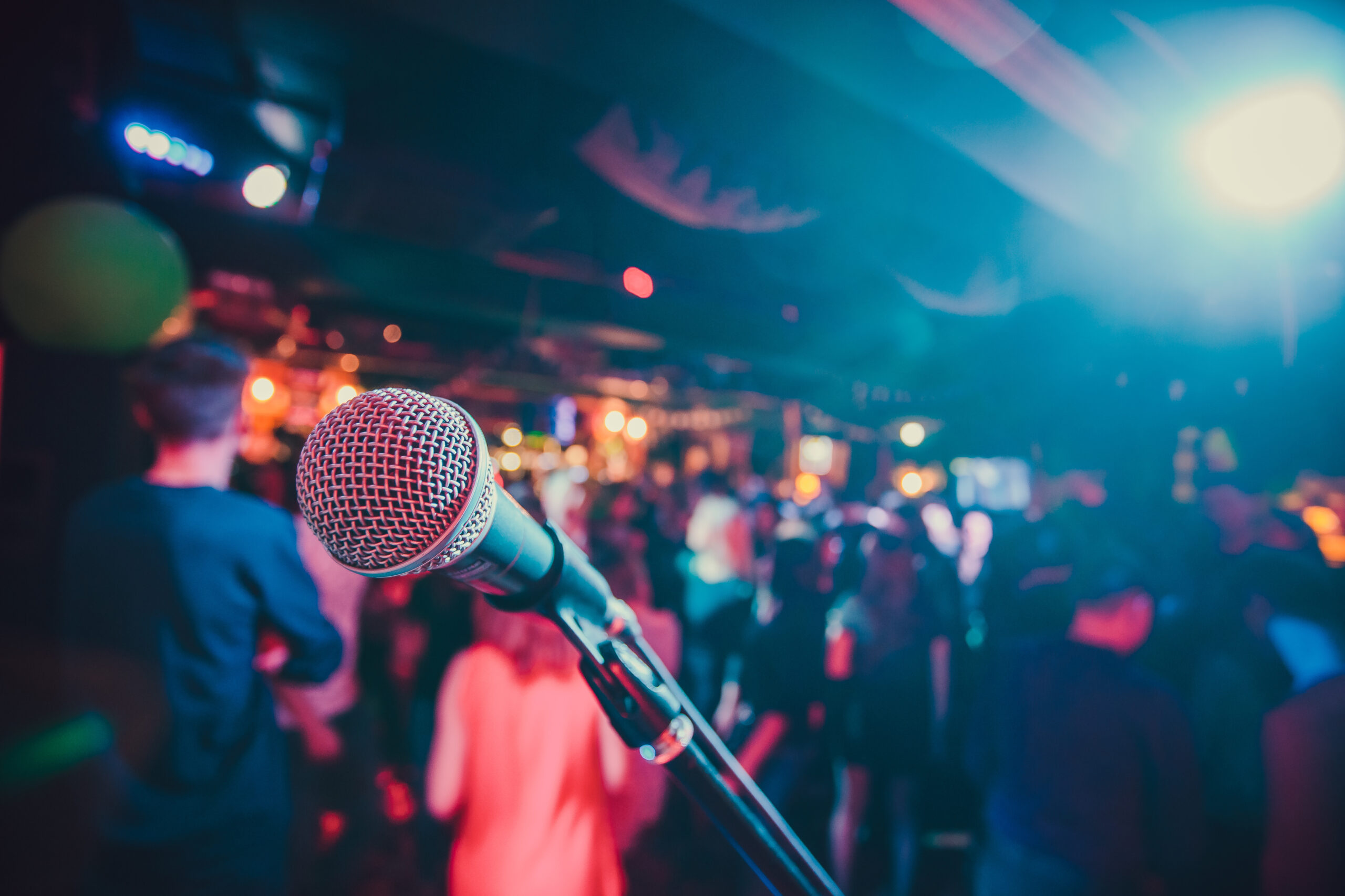 Public performance on stage Microphone on stage against a background of auditorium. Shallow depth of field. Public performance on stage