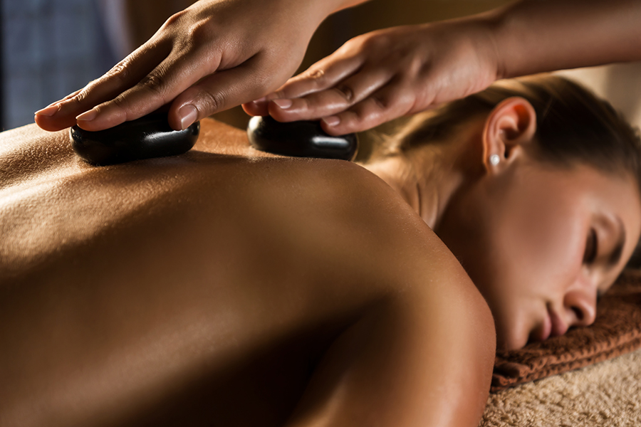 woman enjoys hot stone massage